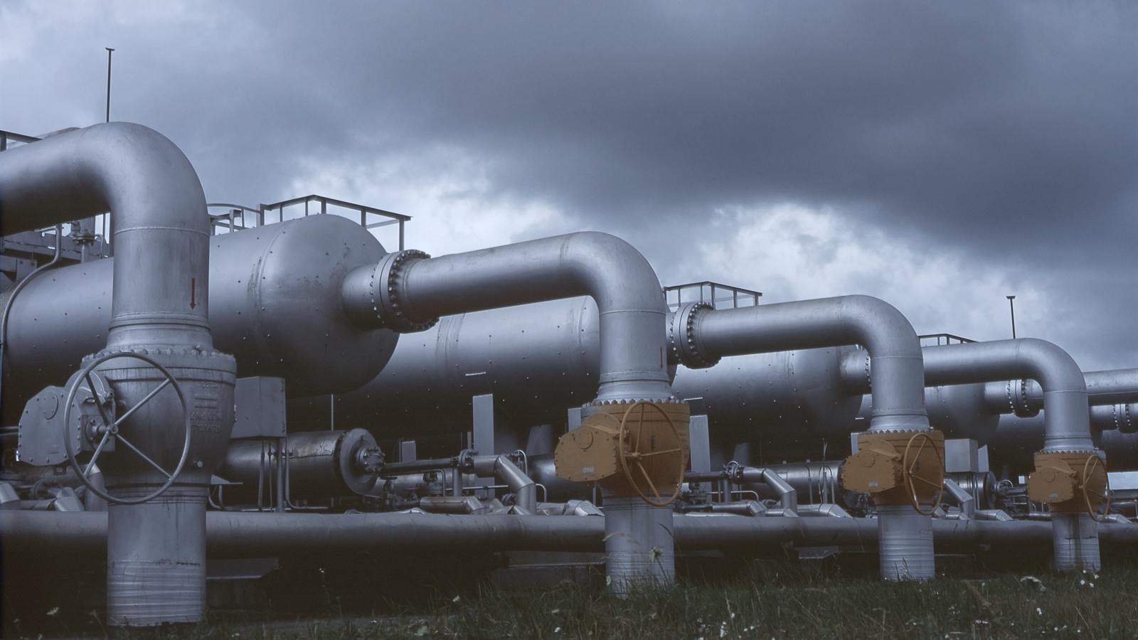 Industrial pipework and valves against the sky