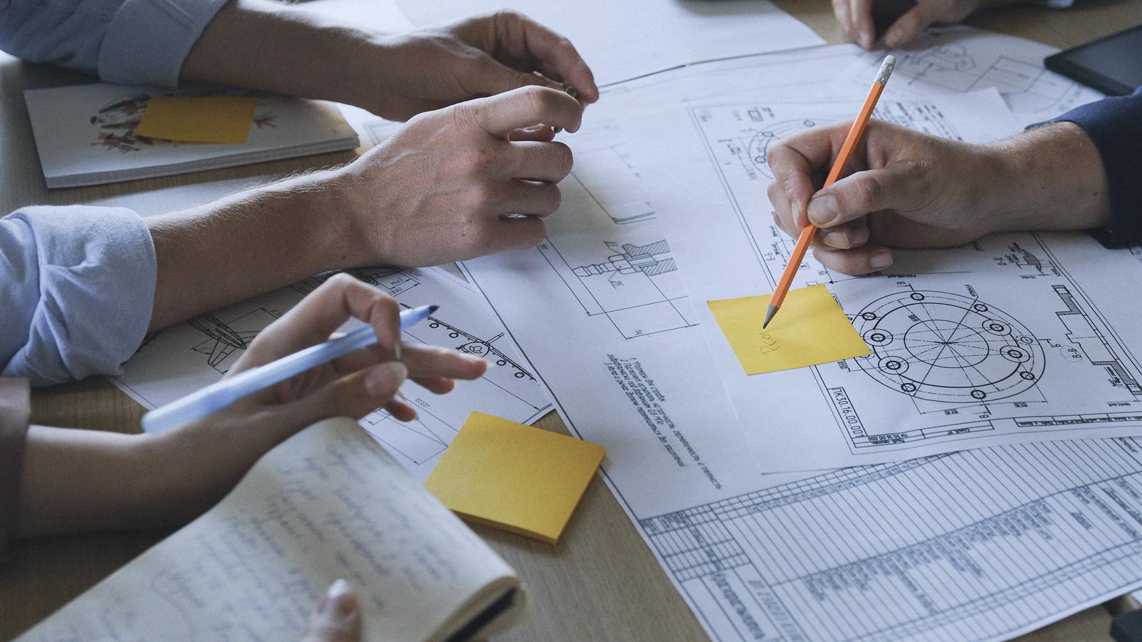 Hands over technical drawings and notes during project planning