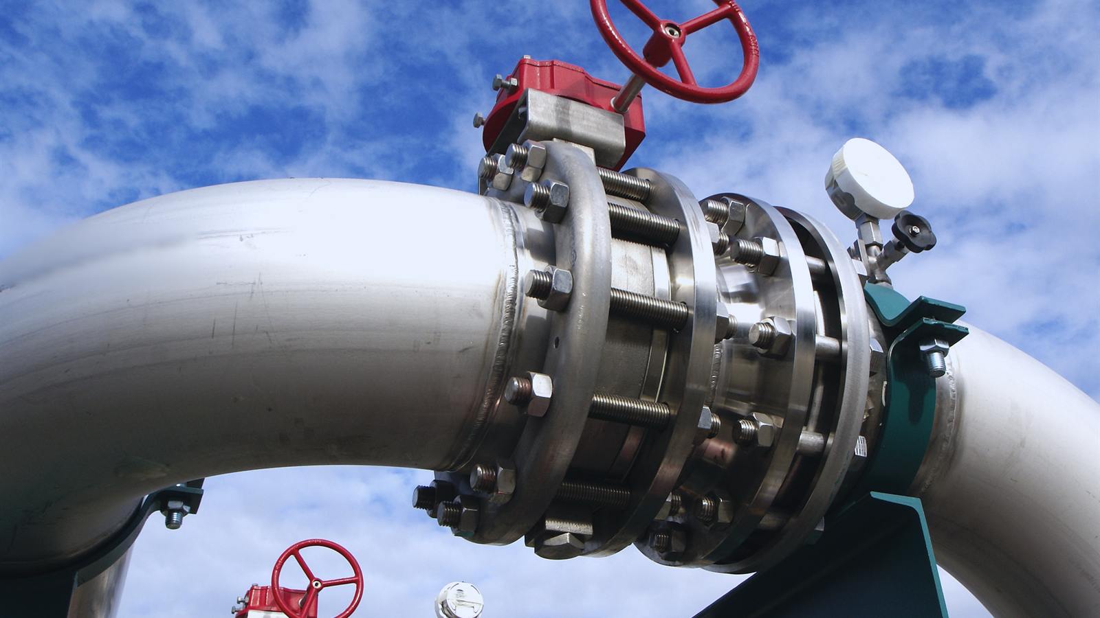 Industrial valve with red handwheel installed on a process line